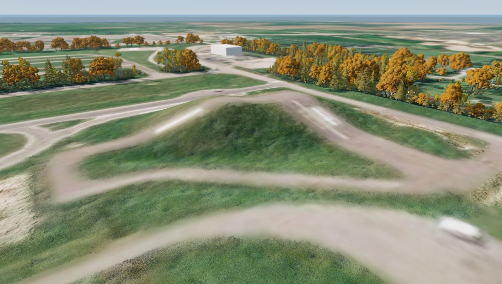 Aerial view of a spawn point on a hill with a looping road